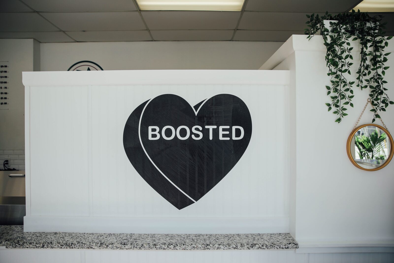 The counter inside the Manayunk shop with the BOOSTED heart behind it