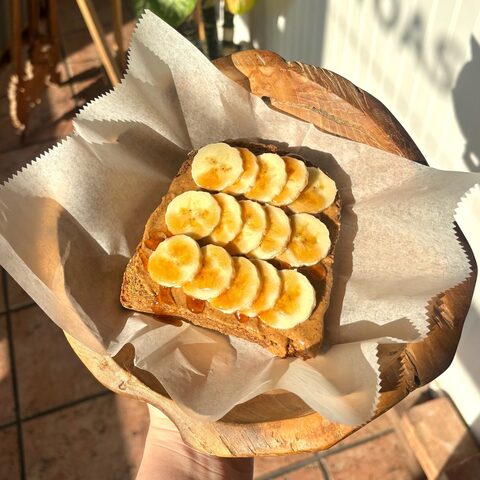 Multigrain toast with almond butter, sliced bananas, and cinnamon honey drizzle