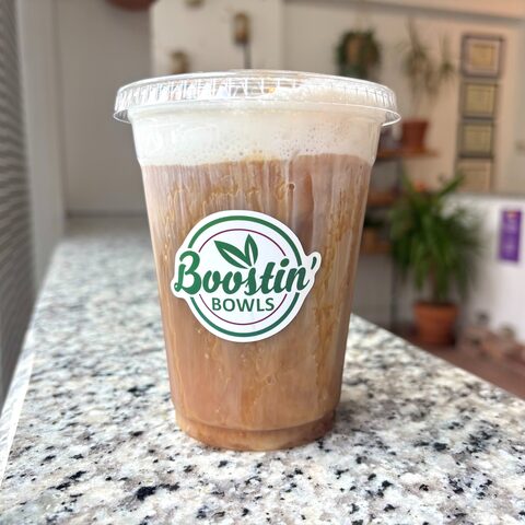 Iced coffee with banana syrup, caramel, and cold foam