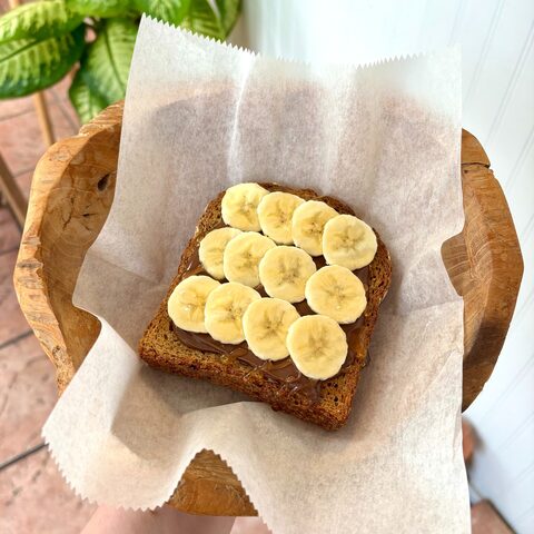 Multigrain toast with Nutella, banana slices, and honey drizzle