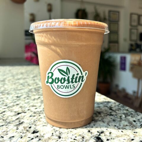 Brown smoothie with coffee, banana, peanut butter, and cocoa powder